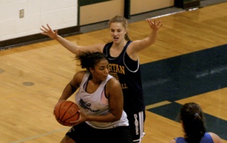 Senior Brittany Gray surveys her next move during practice.