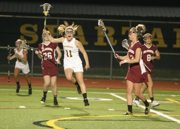 Kelsey Mackin leaps for joy as time runs out against play against Mercer Island and Bainbridge advances to the state title game. Mackin will continue her lacrosse career at Chapman University.