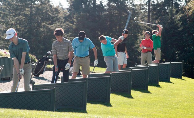 Members of the Bainbridge High boys golf team warm up at the driving range at Wing Point Golf & Country Club prior to hitting the links for a practice round earlier this week. The Spartans hosted their first home match Thursday