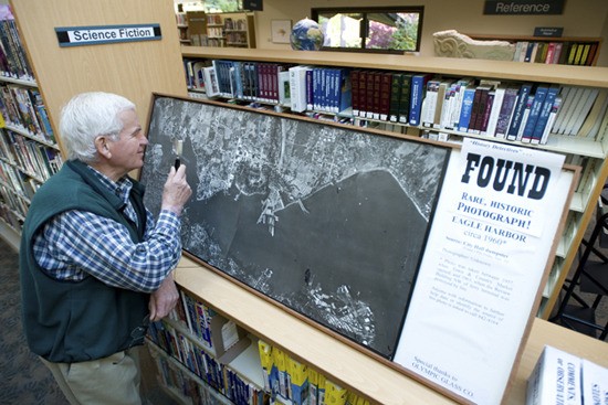 Island historian Gerald Elfendahl examines the historic aerial photo he found in a city hall dumpster in September.