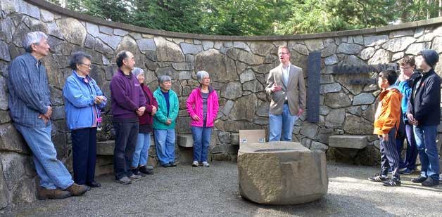 Congressman Derek Kilmer addresses the crowd at the public commemoration of the 73rd anniversary of the first day of the forced Japanese American removal from the island.