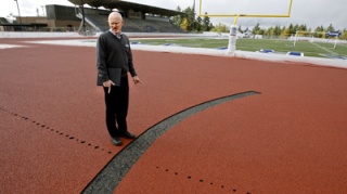 BHS Principal Brent Peterson points out where contractors cut away damaged portions of the track.