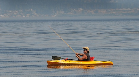 A fisherman enjoys calm water off Fay Bainbridge State Park. Temperatures topped 100 degrees on Bainbridge Wednesday.