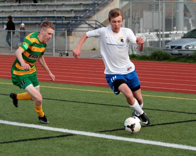 BHS junior Micah Russel drives the ball around the Braves’ defenses during Friday’s ill-fated home match. The Spartans lost 1-0.