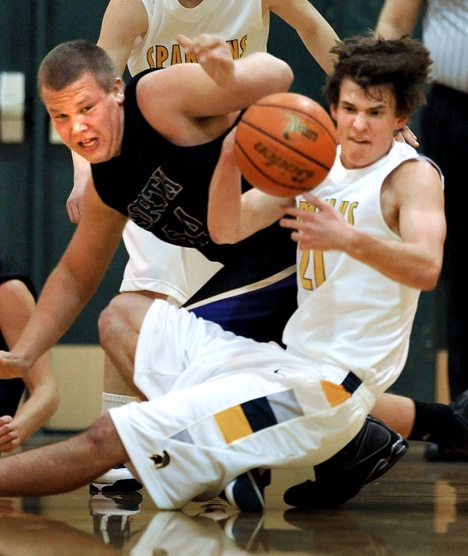 Bainbridge Spartans forward Michael Stevenson battles for the ball with North Kitsap Vikings center David Stock during action Wednesday at Bainbridge. The Spartans beat the Vikings 55-42. Visit back here Thursday for a slideshow from the game.