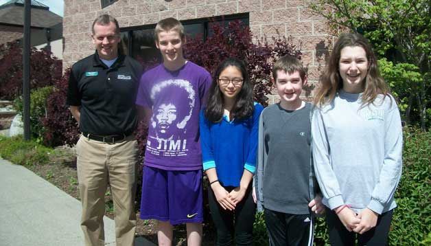 Principal Mike Florian stands with Woodward Middle School’s Students of the Month for April: Alex Loleas