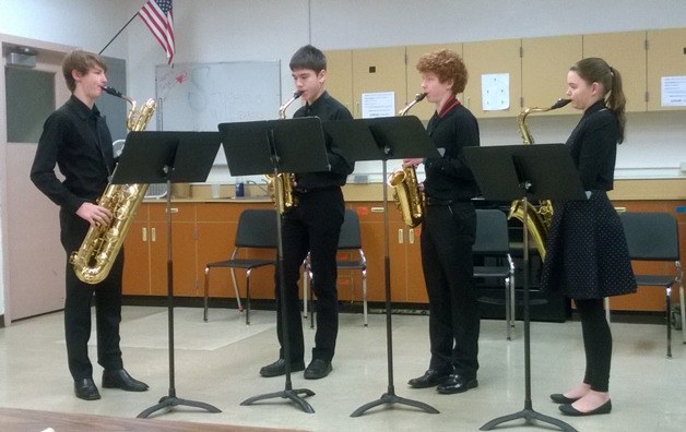 The Bainbridge Saxophone Quartet warms up prior to their performance before the adjudicator (Taylor Lhamon