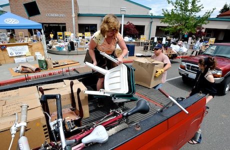 Pam Heater and her daughter Haley work to unload donations Monday at Woodward Middle School. The BI Rotary is hosting its annual live auction and rummage sale this weekend. Check back later Monday for a photo slideshow of some items and activity.