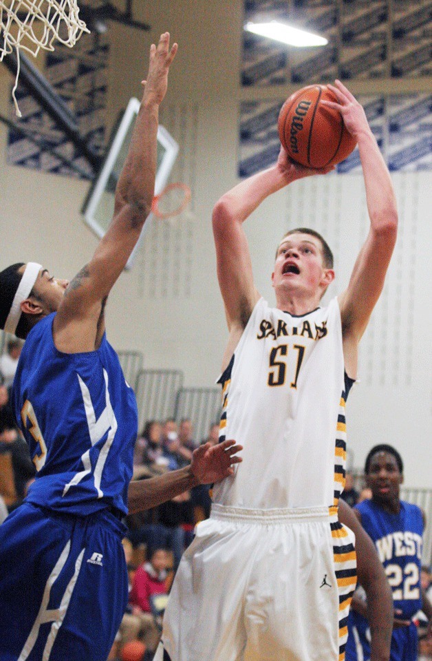 The Spartans' Oskar Dieterich elevates against LaTrey Newsome for 21 of his game-high points in action against West Seattle Tuesday.