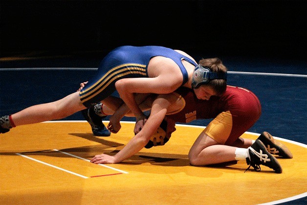 Spartan wrestler Greg Williams grapples with Lakeside’s Hallie Dunham in the 120-pound weight class match during a meet at home Thursday