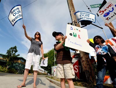 JoEllen and Declan O’Reilly joined fellow supporters of the Save Our Teachers campaign on the corner of Winslow Way and Olympic Drive Wednesday.