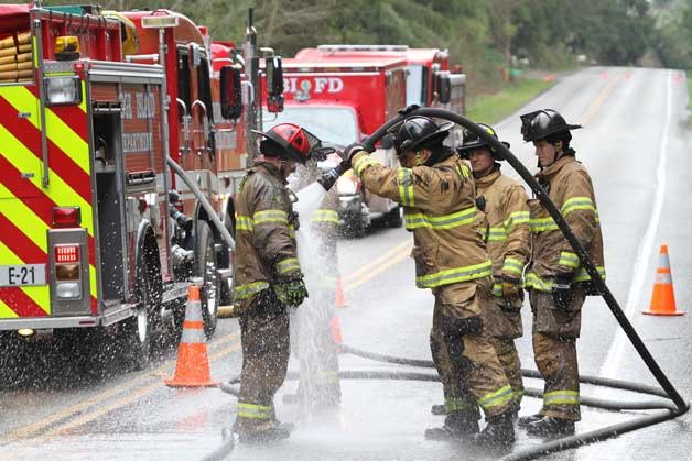 Bainbridge firefighters clean up after battling a fire on Miller Road early Wednesday.