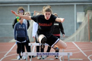 Hurdler Laura Bricklin clears a hurdle during practice Monday at BHS. More than 100 athletes turned out for the track team