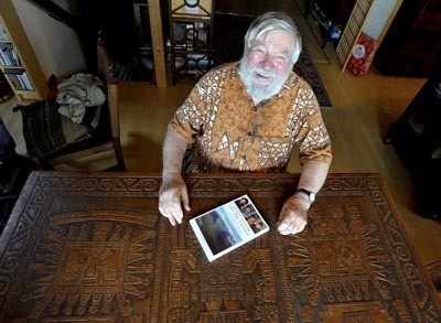 Colin Bull at home on Bainbridge with his latest book.