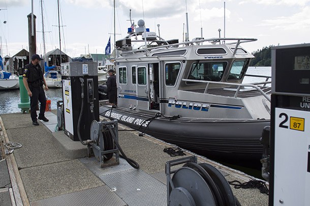 Bainbridge Island Police Department Sgt. Ben Sias and Harbormaster Tami Allen prepare to gas up the BIPD Maritime Services Unit’s larger vessel