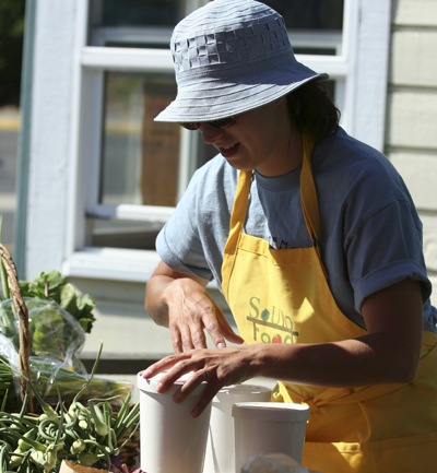 Anne Willhit prepares berries to be sold at Sound Food's ferry farm stand.