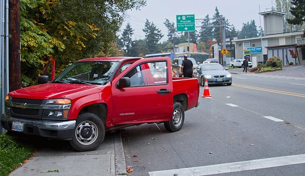 A red Chevy Colorado as well as a gray Ford F-150 were both struck by an as-yet-unidentified driver who reportedly lost control of his car after having gone into diabetic shock at the intersection of Highway 305 and Winslow Way at approximately 7 a.m. Thursday