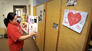 Serenity Program Coordinator Jay Zosa holds a collage memorializing former Serenity Court resident Jack Norris