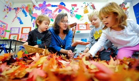 Island Cooperative Preschool teacher Ellen Carleson works with students Rowan Schick