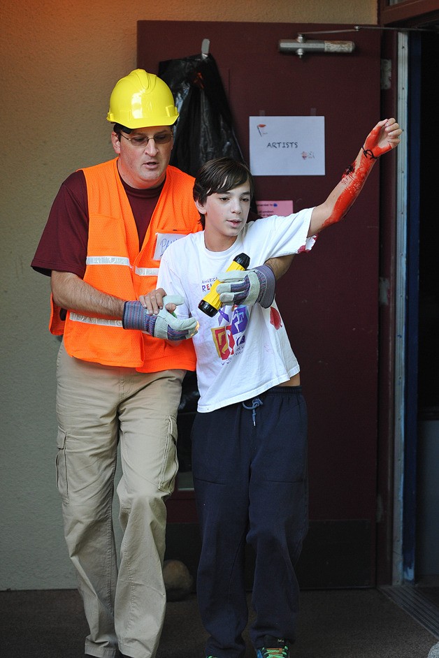 An earthquake drill was conducted Wednesday in Kitsap County. Commodore Options School was the site of technical rescue operations with school safety officers. Teacher Paul Meehan and student Keivan Kehlhofer work through their roles in the rescue scenario.