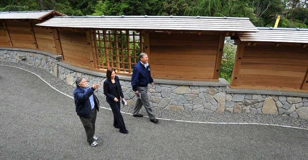 Bainbridge Island Japanese American Community President Frank Kitamoto gives Rep. Jay Inslee (D-Wash.) and U.S. Sen. Maria Cantwell (D-Wash.) a tour of the Japanese American Exclusion Memorial wall Tuesday. When finished