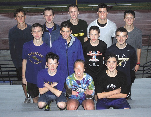 The Spartans’ state-bound runners gather for a photo after a rainy day of practice earlier this week. In front