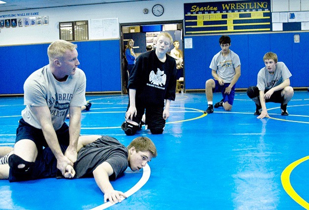 Bainbridge High wrestling team Head Coach Dan Pippinger demonstrates various holds during a recent practice session. 'It's very technical