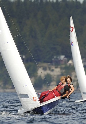 Crewman Lee Gibbes (front) and helmsman Jake White catch a strong wind off Madison Bay Saturday during a Northwest Youth Racing event. The two members of Sail Orcas won seven of the 15 races in the Vanguard 15 class Saturday and Sunday to place first ahead of 13 other boats. The Port Madison Yacht Club event had about 70 racers competing in four classes.