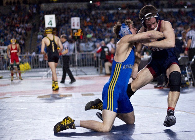 Bainbridge senior wrestler Dylan Read grapples with Hayden Hohman of Mount Spokane during his first match of of the 2014 Mat Classic XXVI State Wresting Tournament Friday