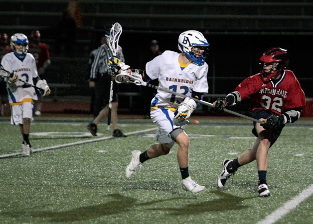 BHS player Ben LaRoche pushes through the defensive efforts of the visiting Nathan Hale.