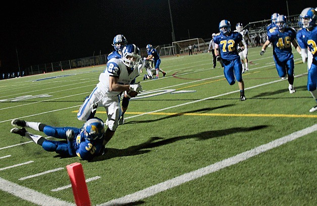 Spartan defensive back Duncan McCombs tries to stop the first Seattle Prep touchdown during the Bainbridge homecoming football game Friday