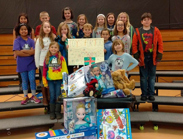 Ordway students gather around the donations they helped collect this holiday season for Toys for Tots.