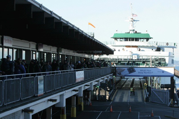 Walk-on passengers get off the Bainbridge ferry at the Seattle terminal.