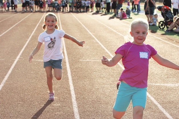 Ella Hatletveit is right on the heels of Carlyn Moore as the pair near the finish line during Monday’s All-Comers Track Meet. Carlyn placed first in the 200 meters