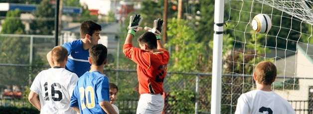 Michael Crowley scores on a header past Glacier Peak goalkeeper Lucas MacMillian for the Spartans’ first score.