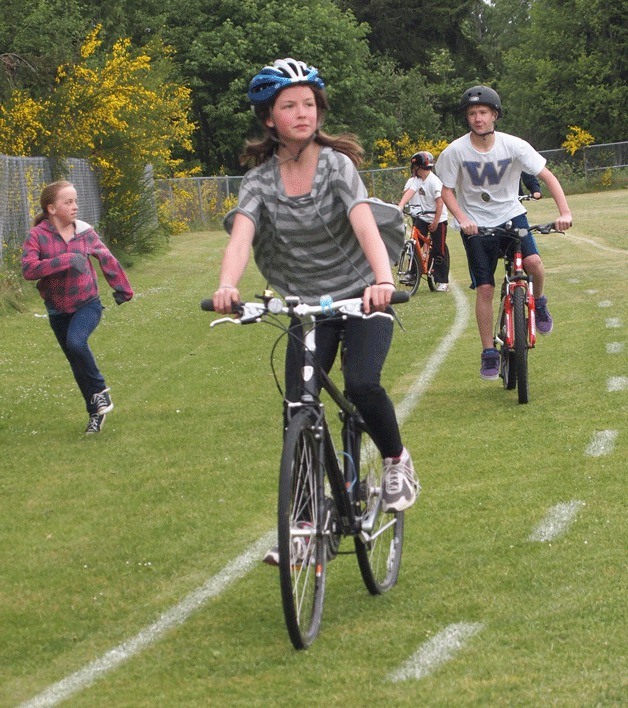 Students at Sakai ride their bikes on a special course at their school's ball field.