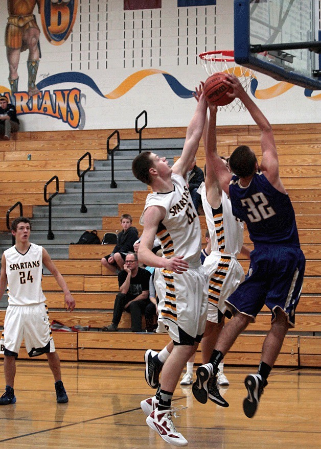 Oskar Dieterich moves in to block a shot by North Kitsap during the Spartans' first home game of the season.