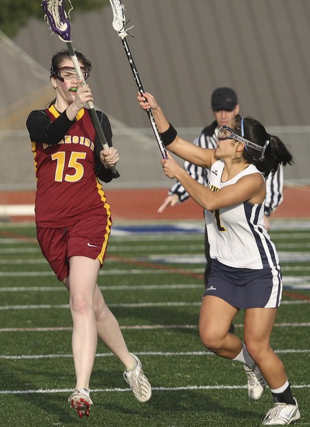 Liana Olson tries to stop Lakeside's Jade Blake-Whitney from making a pass in the first half of the Spartans' 18-12 win over the Lions Wednesday night at Bainbridge High School.