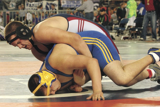 The Spartans’ Mike Grant tries to prevent Tom Harbey of Mount Spokane from gaining control during their first-round matchup. Harvey went on to claim second place in the tournament.