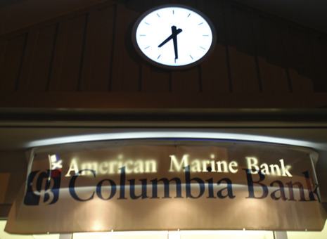 Sign of the times: The sign in front of American Marine Bank's headquarters Friday night reflected the change in ownership.