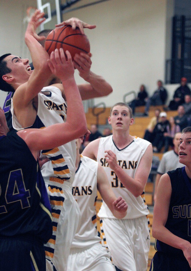 Joey Blacker is mugged from behind on his way to the basket during the Spartans' win against Sumner Saturday.