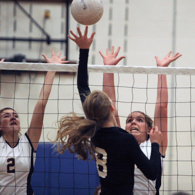 Riley Kulfan and Lauren Sheehan rise to block a shot by Karlie Holdren of Central Kitsap during Friday's Spartan volleyball win at Paski Gymnasium.