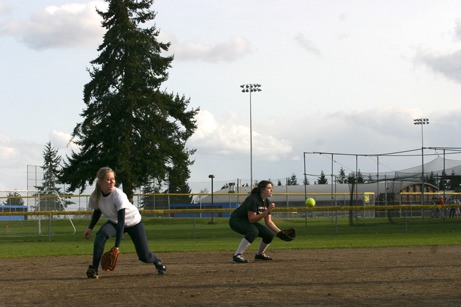 BHS players Lauren Reichert and Isabelle Minasian field ground balls.