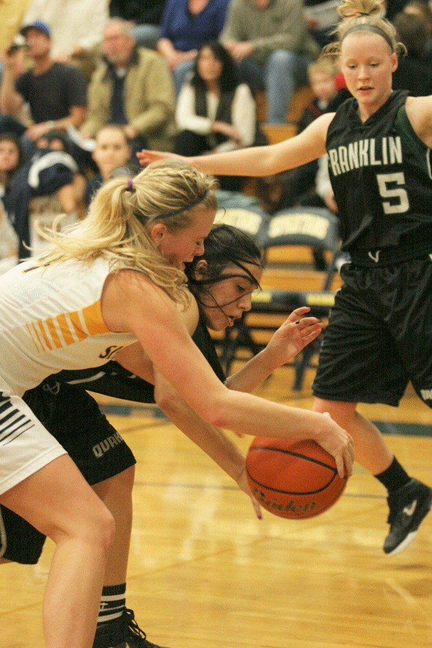 The Spartans' Sydney Severson battles Jazmin Horne for a rebound during first-half action in the Metro League matchup.