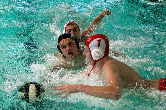 Spartan boys water polo team captain Jem Bullock splashes and scrambles for the ball during last Friday’s match against Newport High.