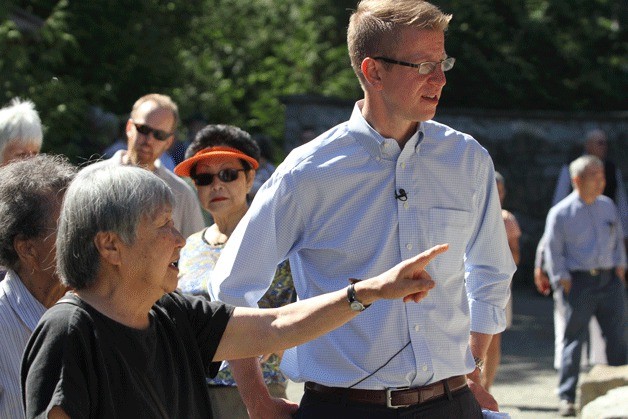 U.S. Rep. Derek Kilmer takes a tour of the Japanese American Exclusion Memorial with survivors of the World War II internment camps on Aug. 4. Many survivors shared stories and pointed out their names