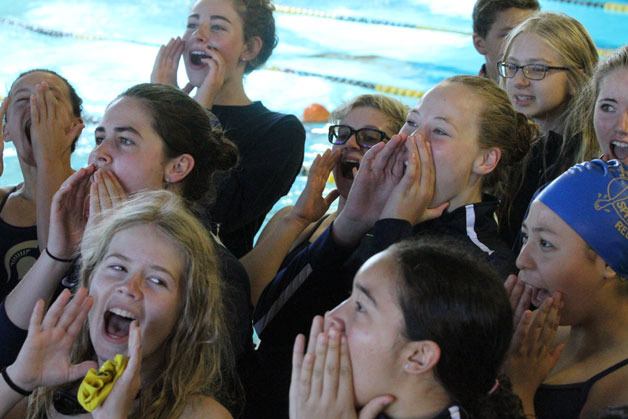 Members of the Bainbridge girls swimming and diving team scream out a pre-meet cheer before the start of the Spartan Relays invititational on Saturday at the Bainbridge Island Aquatic Center.