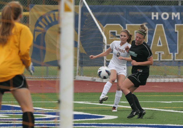 Spartan Rosie Kerstetter powers past a Bishop Blanchet Braves defender on her way to the goal in Bainbridge's 7-1 win Friday.