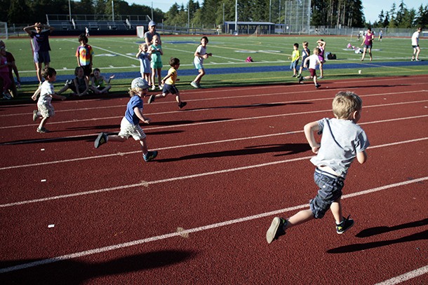 Young runners sprint to the finish line during the 60-yard dash event at the Kiwanis All-Comers Track Meet on Monday