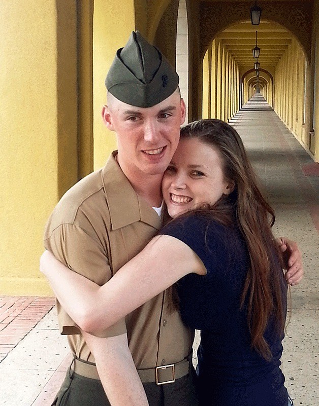 Lance Cpl. Andrew Riley gets a big hug from his younger sister Anna Riley after his graduation.